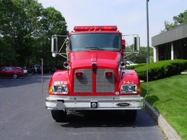 Front exterior view showing grille, bumper, and warning lights