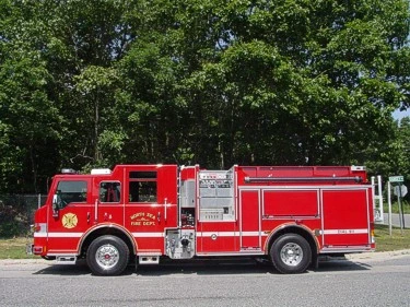 Full right-side profile showing pump panel location, side compartments, and wheel/tire layout.