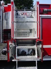 Open side compartment close-up with pull-down tray, panel controls, and mounted equipment space.