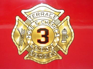 Cab door close-up showing circular company crest on red panel
