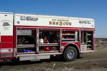 Officer-side view with open compartments showing tools, equipment storage trays, and wheel area.
