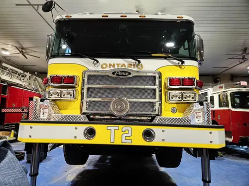 Head-on front view showing grille, bumper intakes, and warning lights
