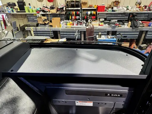Cab interior console view showing center work surface and cup-holder mounts