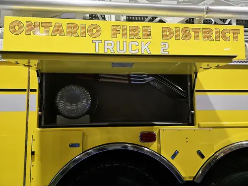 Side body lettering panel view above rear wheel with open upper compartment