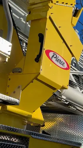 Outrigger close-up showing deployed jack pad and yellow stabilizer arm