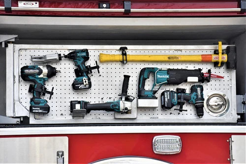 Open side compartment showing mounted hand tools and long-tool rack