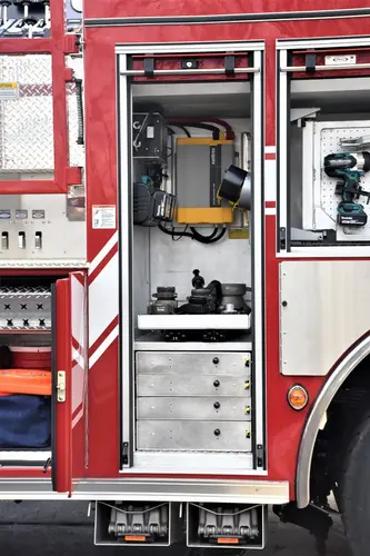 Open narrow side compartment showing vertical storage channel and fittings