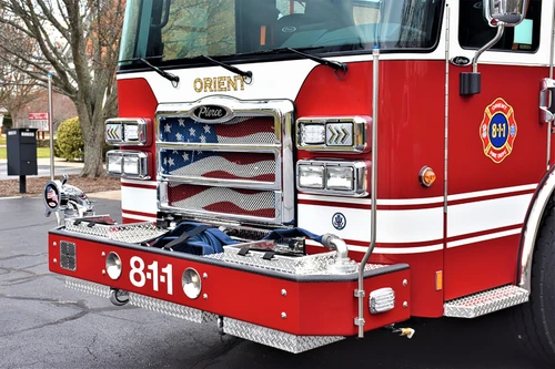 Front bumper close-up showing intake ports, chrome grille, and warning lights
