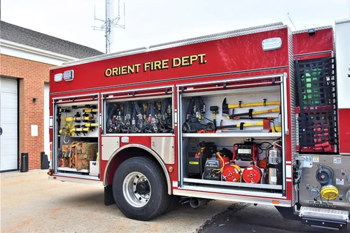 Driver-side profile with compartments open showing tools and storage shelves