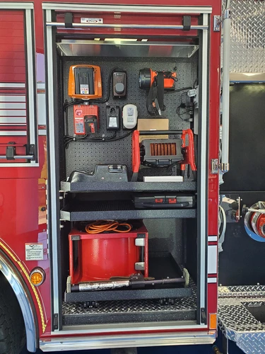 Open side compartment showing generator and tool storage layout