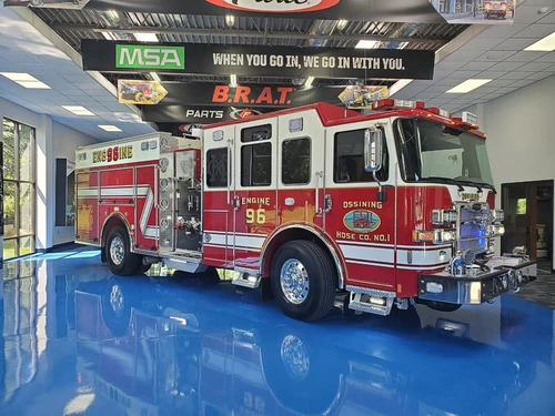 Driver-side profile view showing pumper body in apparatus bay
