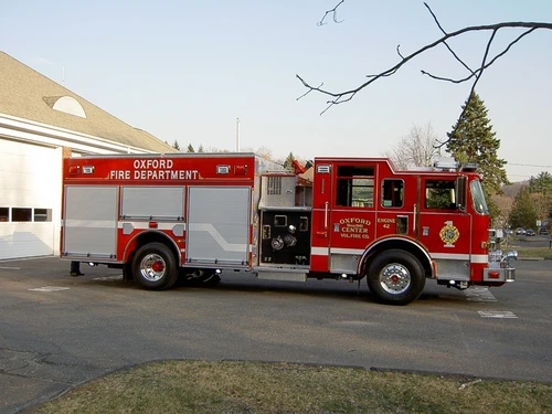 Driver-side profile view with open pump panel and side compartments