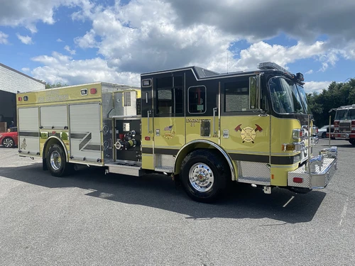 Rescue pumper front-left exterior view showing yellow body and enclosed cab