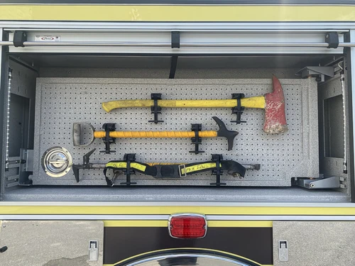 Open side compartment showing mounted hand tools and horizontal rack layout