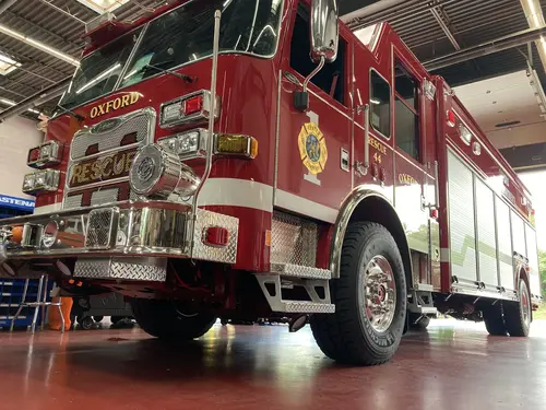 Pumper front-left exterior view showing grille, bumper, and side compartments