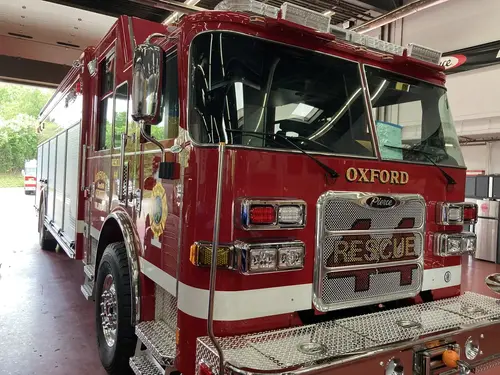 Front-left exterior view showing cab corner, grille, and bumper