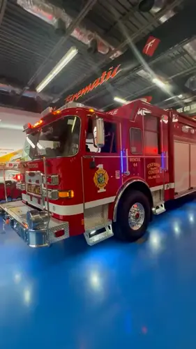 Front-right exterior view with warning lights illuminated and side body visible