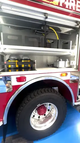 Open side compartment above rear wheel showing shelf storage and wheel arch
