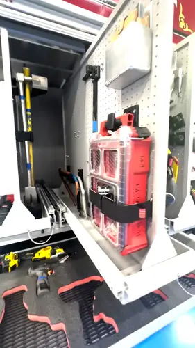 Open side compartment showing extinguisher mount and vertical tool storage