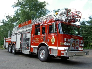 Front-left exterior view showing bumper, cab, and ladder sections