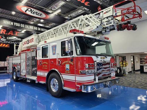 Tower ladder truck front-left exterior view showing cab and ladder bed