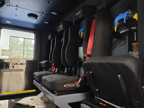 Cab interior side view showing rear seats and center aisle