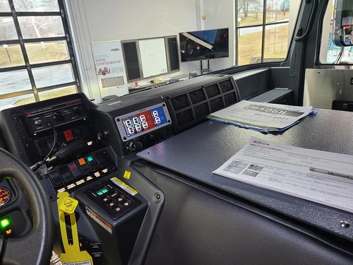 Driver cockpit view showing dashboard controls and center console