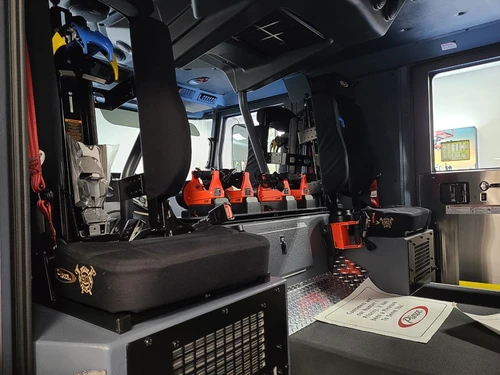 Cab interior side view showing seat row and side wall mounts