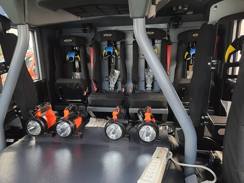 Rear crew-seat close-up showing SCBA seat backs and restraints