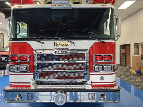 Head-on front view showing grille, bumper, and warning lights