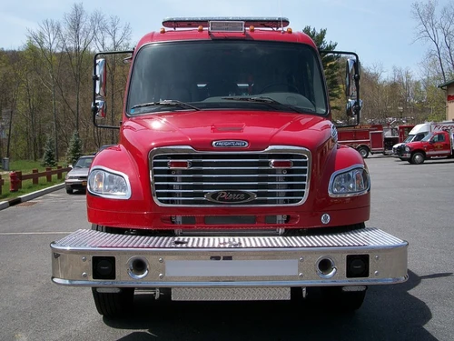 Head-on front view showing the grille, headlights, windshield, and bumper intake ports.