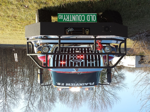 Front exterior view showing grille guard, bumper, and warning lights