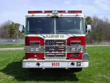Head-on front view showing grille, bumper, and warning lights