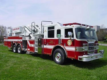 Front-right exterior view showing cab, side body, and ladder turntable area
