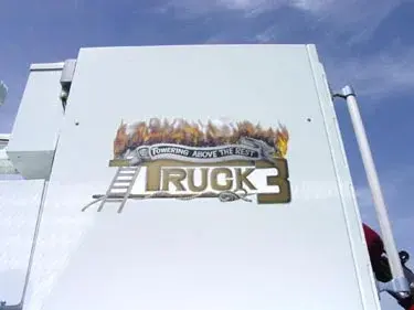 Bucket side panel close-up showing Truck 3 flame-style logo graphic