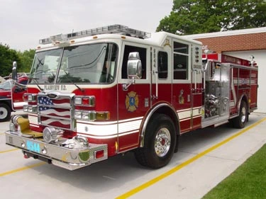 Pumper front-left exterior view showing enclosed cab and side compartments