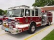 Pumper front-left exterior view showing enclosed cab and side compartments