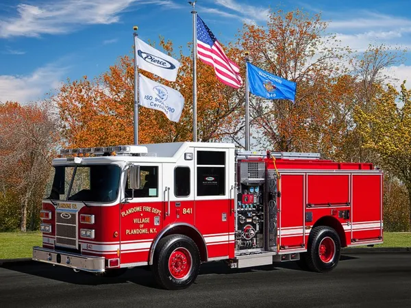 Pierce Saber pumper front-left exterior view with pump panel and enclosed cab