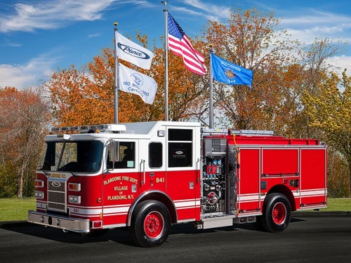 Pierce Saber pumper front-left exterior view with pump panel and enclosed cab