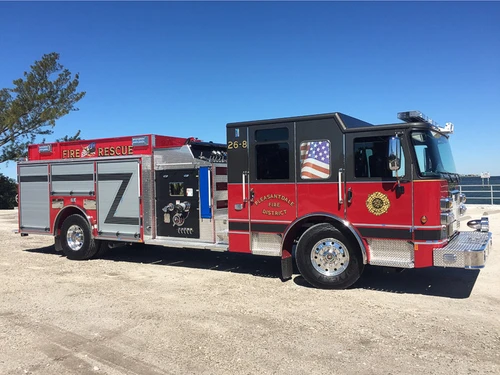 Rescue pumper side profile view showing enclosed cab and side compartments