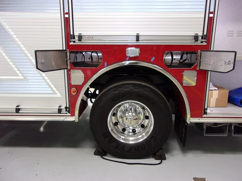 Rear wheel and lower body close-up showing tire, trim, and side panel