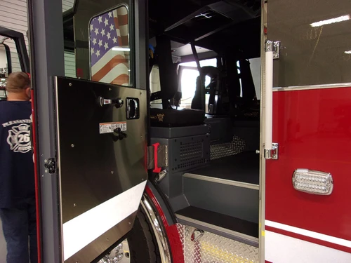 Cab side compartment view showing open door and walk-in rescue area