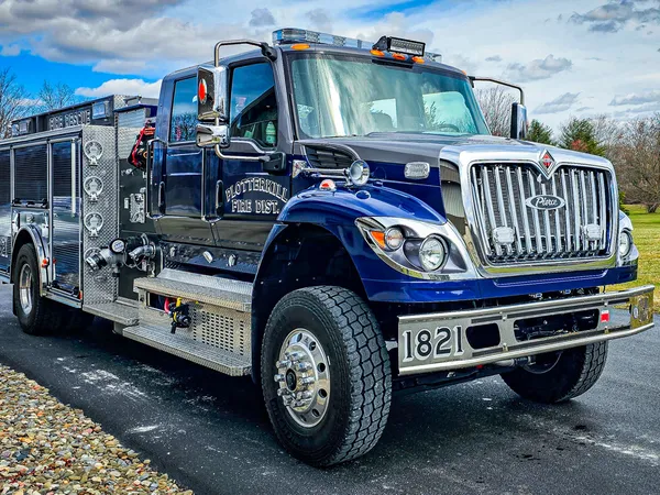 Rescue truck front-left exterior view showing blue cab and long body