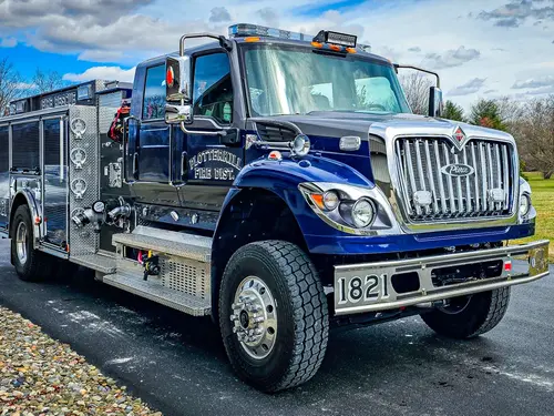Rescue truck front-left exterior view showing blue cab and long body