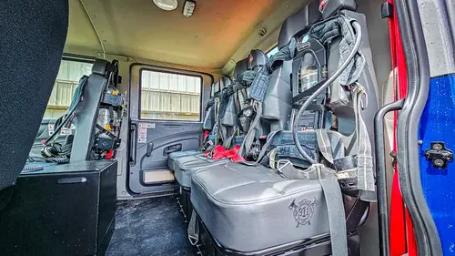Cab interior side view showing rear seats and center aisle area