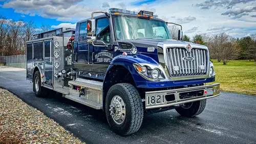 Rescue truck front-left exterior view showing blue cab and side profile