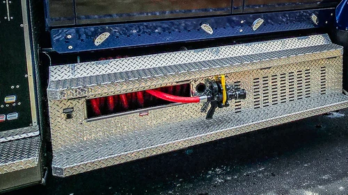 Lower side compartment close-up showing tray opening and underbody step