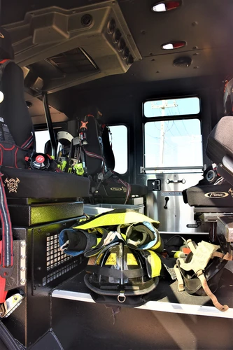 Cab interior view showing front seats, center aisle, and dashboard area