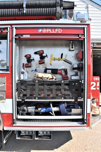Open side compartment showing tools and fittings arranged on shelves