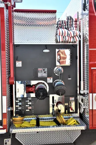Open side compartment showing control module area and warning label panel